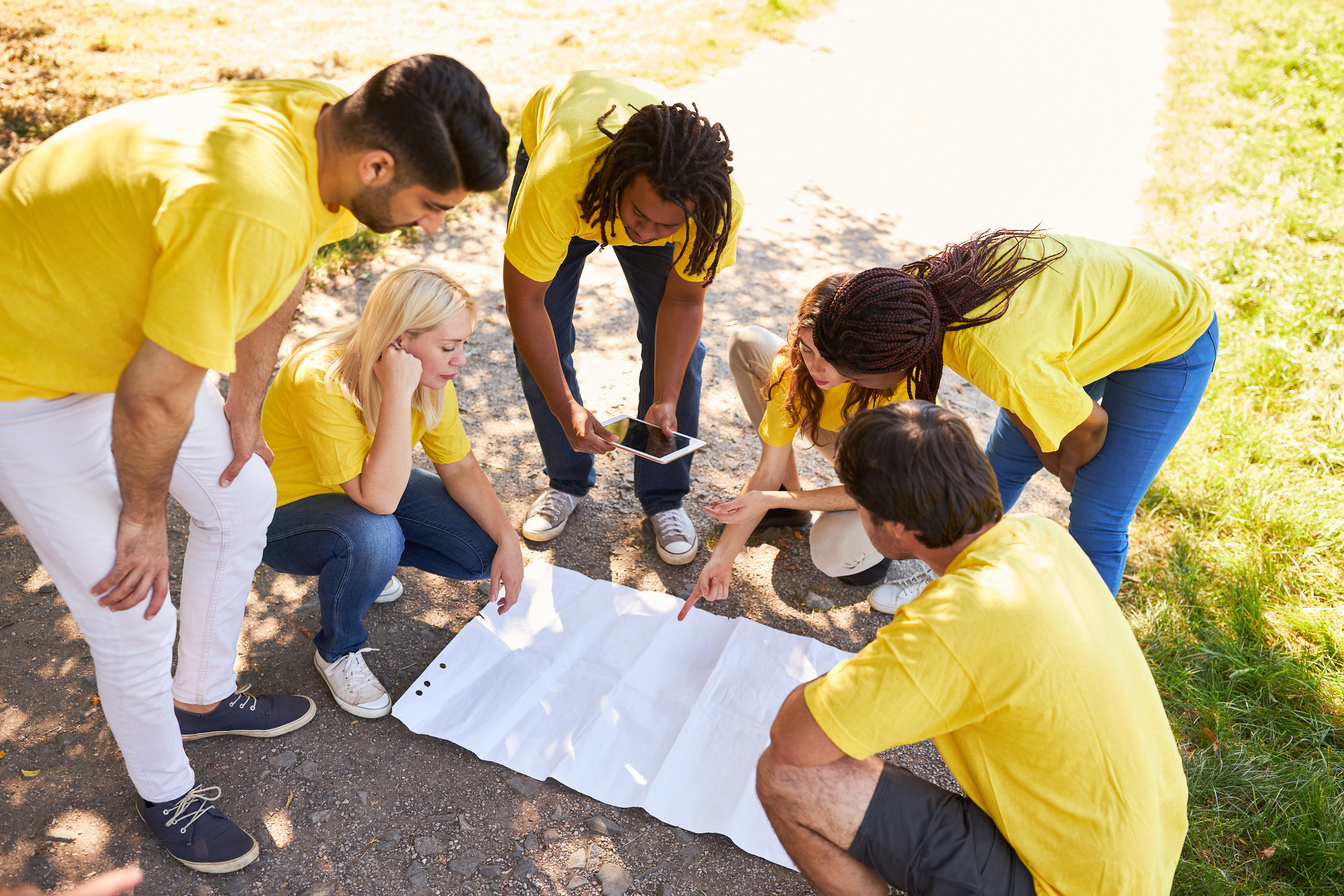 Young Start-up Team on a Treasure Hunt with a Map